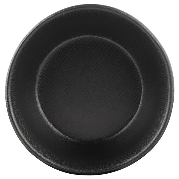 A close-up of a black round bowl with a textured surface.