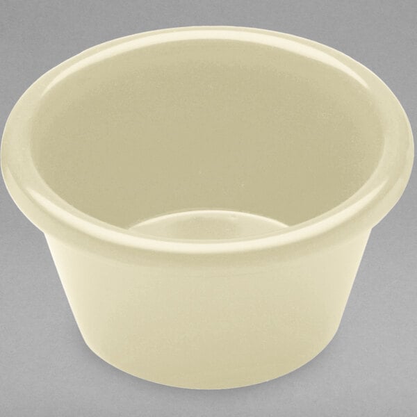 A vanilla-colored melamine ramekin with a circle design on a white background.