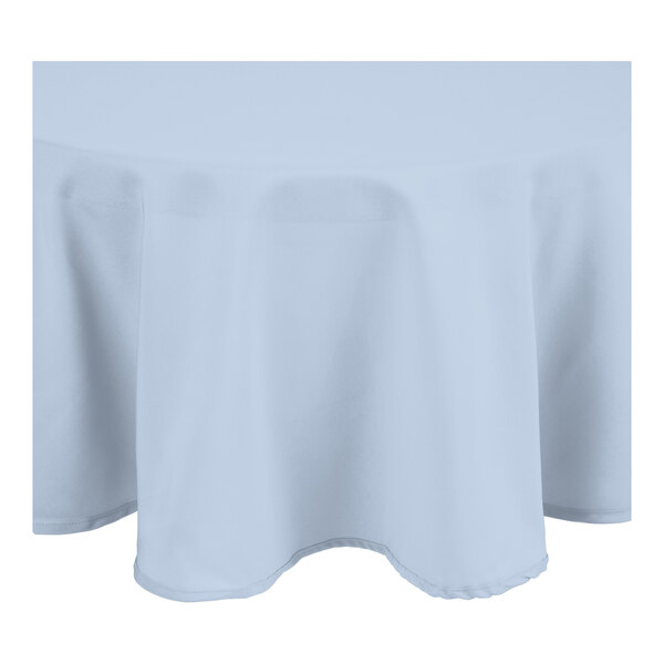 A light blue round tablecloth with a white hem.