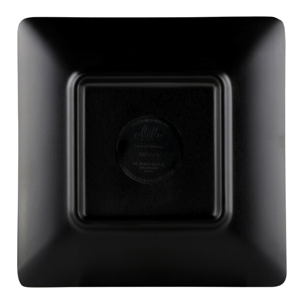 A black square Elite Global Solutions Karma melamine plate with a black square and circular logo.