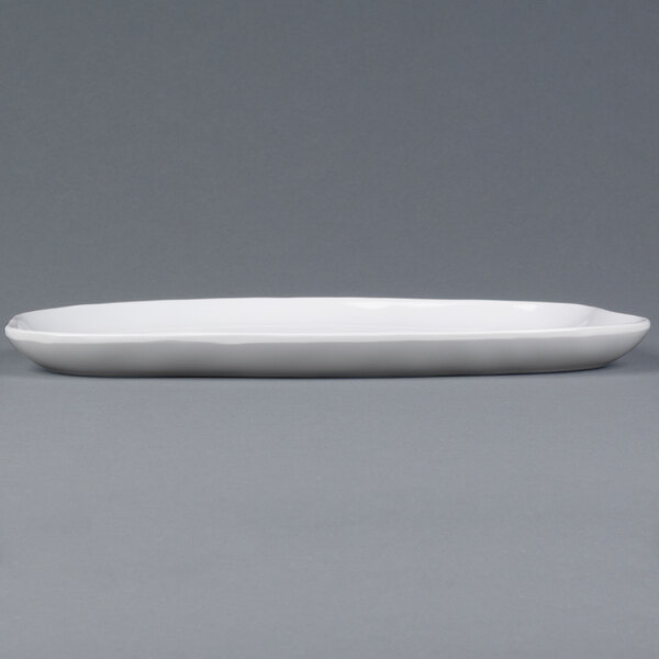 A white rectangular Elite Global Solutions melamine plate with an irregular edge.