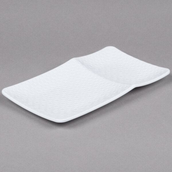 A white rectangular melamine platter with curved edges.