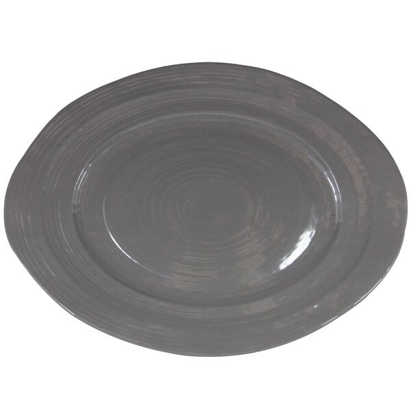 A grey oval melamine serving dish with a spiral pattern.
