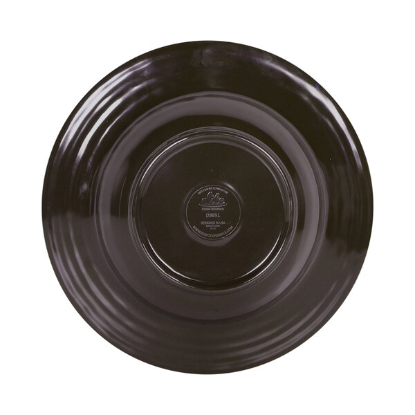 A black melamine bowl with a brown rim and a circle in the middle.
