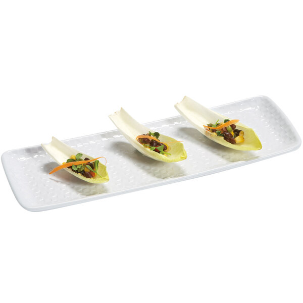 A white rectangular melamine platter holding three small dishes of food.