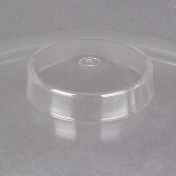 A clear plastic lid with a round top.