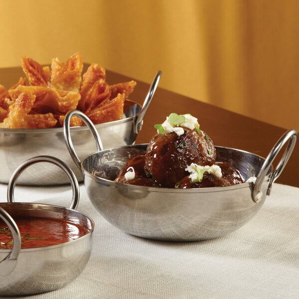 An American Metalcraft stainless steel balti dish filled with food.