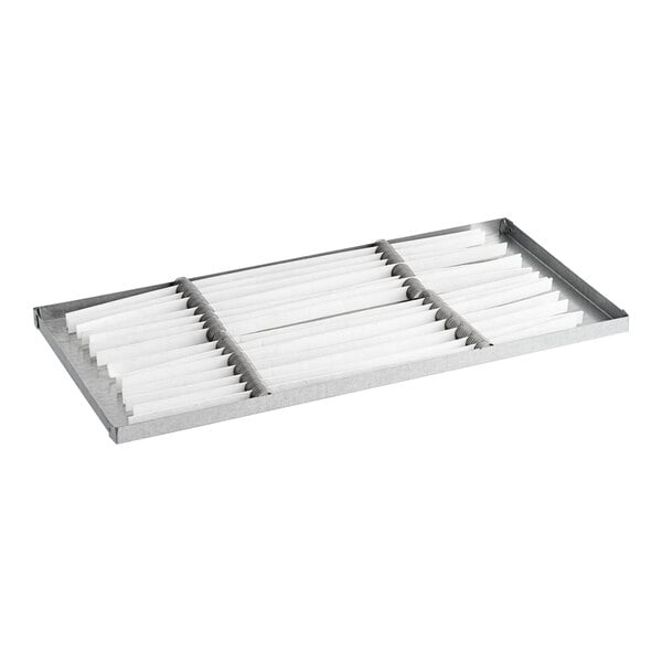 A Beverage-Air condensate pan assembly with white paper in it.