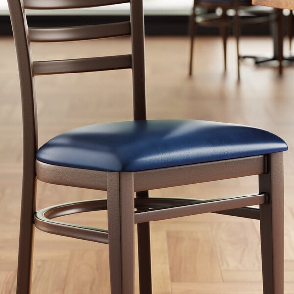 A Lancaster Table & Seating chair with a navy cushion on a wooden table.
