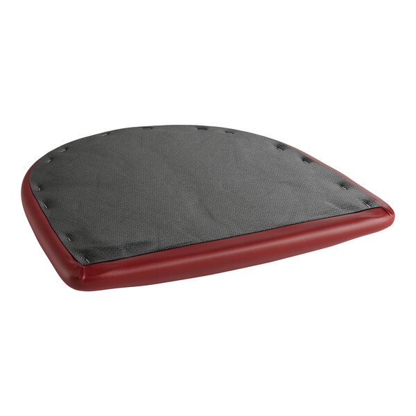 A red cushion for a chair or barstool with a black cover.