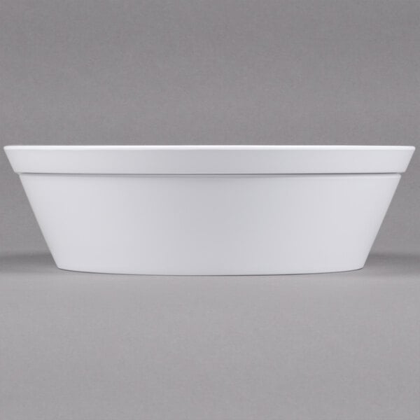 A white rectangular melamine bowl with a white border on a white surface.