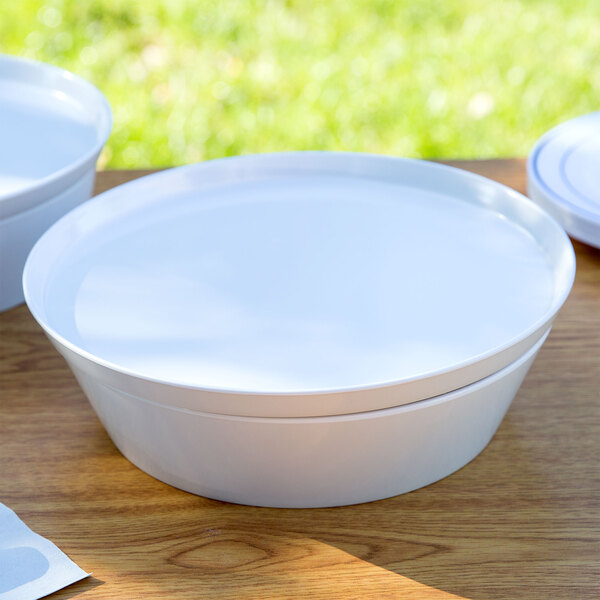 A white Cabana melamine bowl with a lid on a wood table.