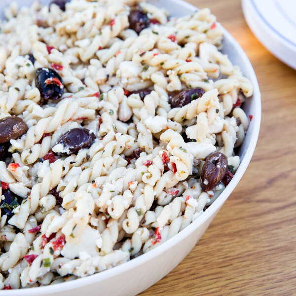 A white melamine bowl filled with pasta.