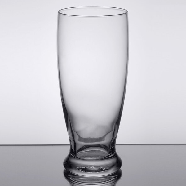 A close-up of a Libbey Atrium cooler glass with a rim on a table.