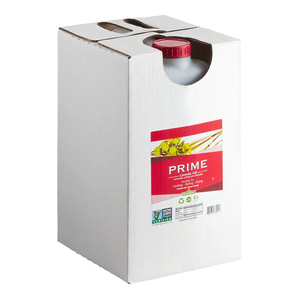 A large white box with a red-capped container inside, partially visible through a cutout, and a red label on the front indicating it is canola oil.