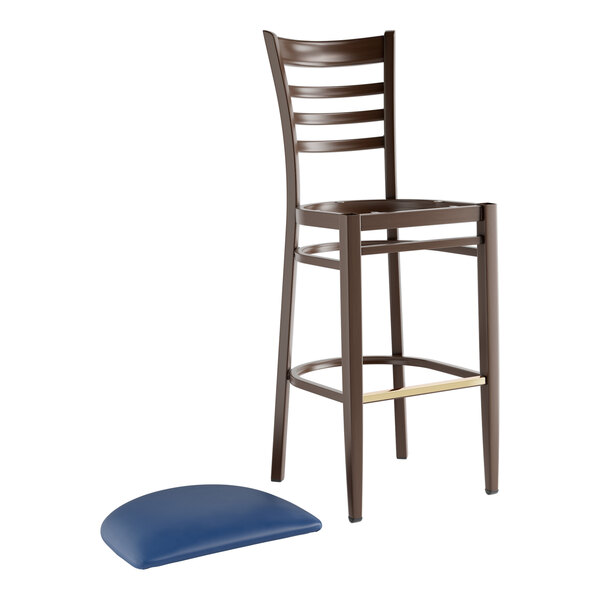A metal ladder back bar stool with a dark walnut wood grain finish and a separate navy vinyl seat cushion.