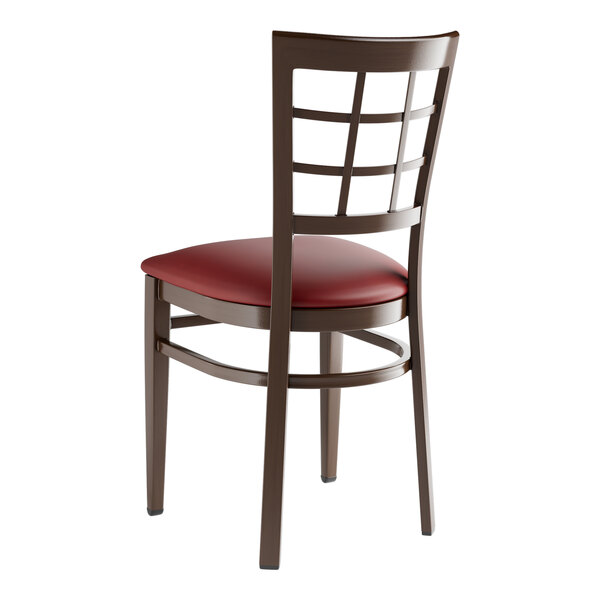 A Lancaster Table & Seating metal window back chair with a burgundy vinyl seat.