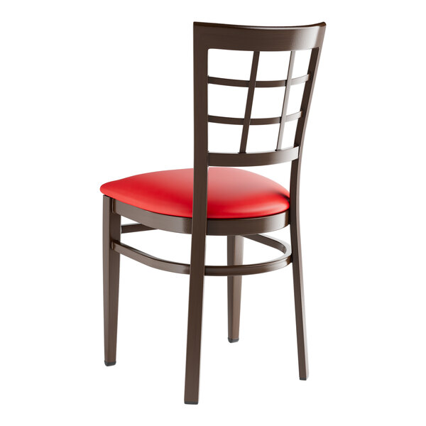 A Lancaster Table & Seating metal window back chair with a red vinyl seat.