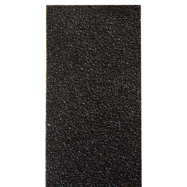 A close-up of a black rectangular surface with 3M Safety-Walk tape on it.