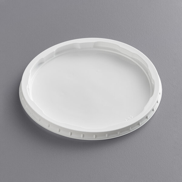 A Choice white plastic lid on a gray surface.