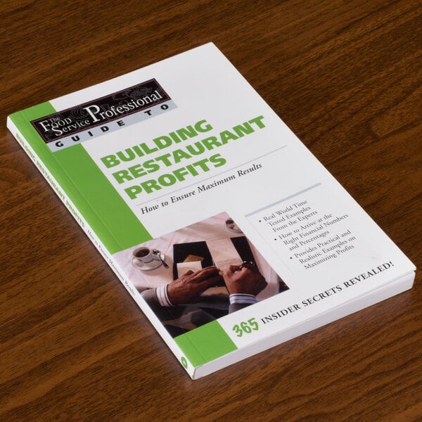 A book titled "Building Restaurant Profits" on a table.