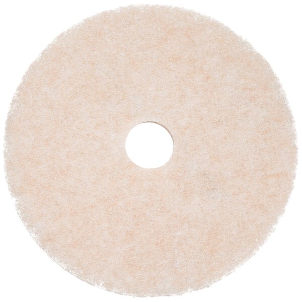 A white circular 3M TopLine Speed floor pad with a hole in the middle.