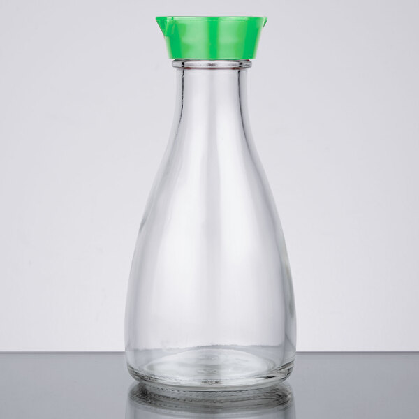 A close-up of a clear glass Town soy sauce bottle with a green top.