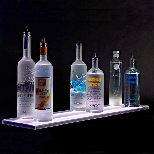 A Beverage-Air liquor shelf holding several bottles of alcohol with built-in LED lighting.