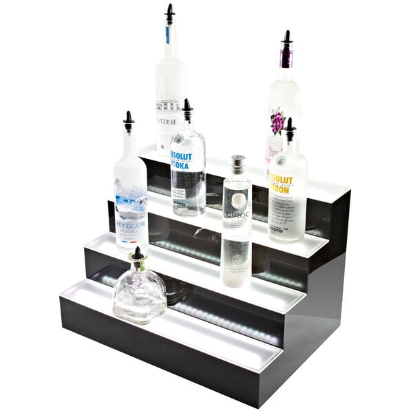 A Beverage-Air three-tiered liquor display holding bottles of vodka with built-in LED lighting.