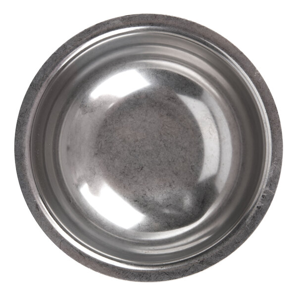 A close-up of a Vollrath butter melter cup with a silver rim.