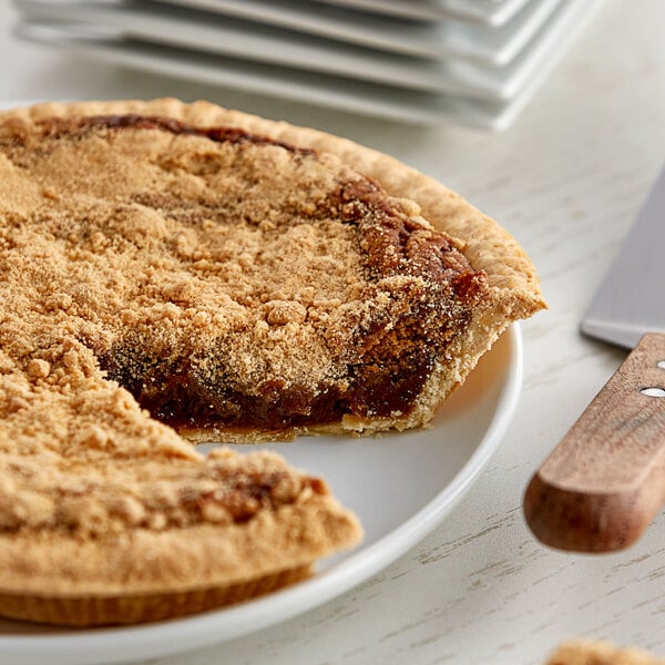 A Golden Barrel Shoofly pie on a plate with a knife and fork.