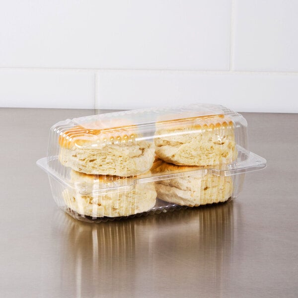 A Dart clear plastic high dome oblong container holding two scones.