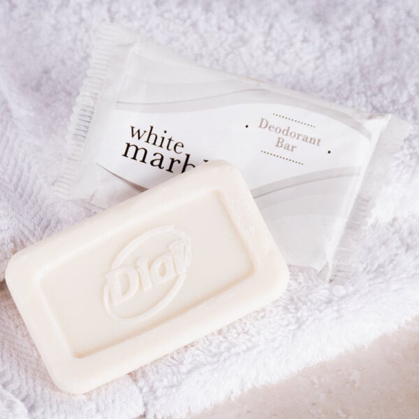 A white bar of Dial White Marble Deodorant Soap on a towel.