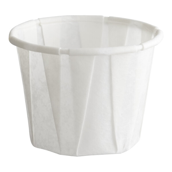 A small white paper souffle or portion cup.