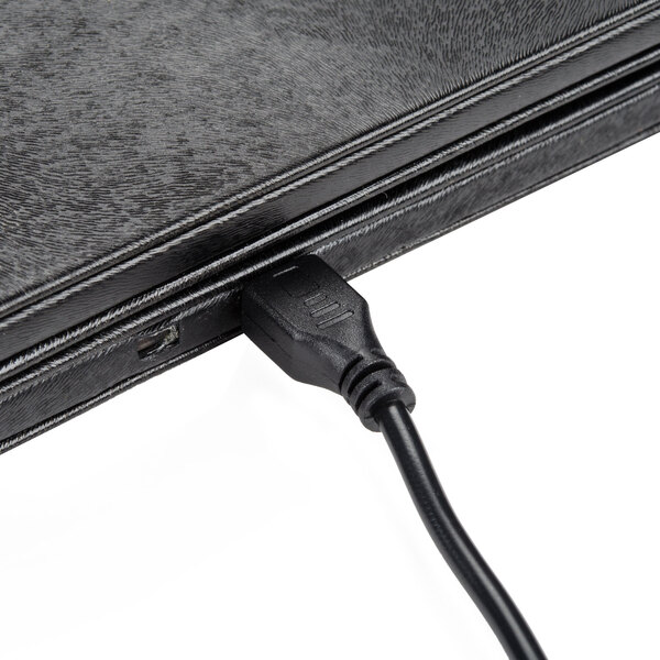 A black cord plugged into an American Metalcraft black leather check presenter.