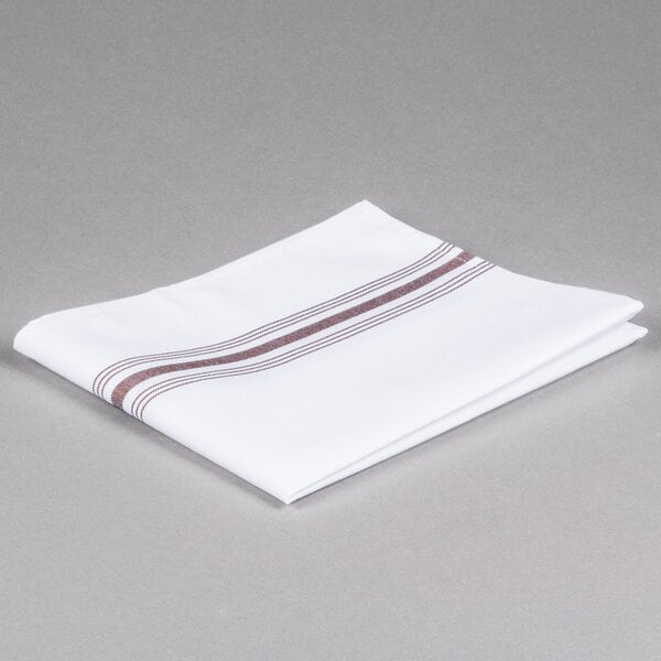 A folded white napkin with brown stripes.