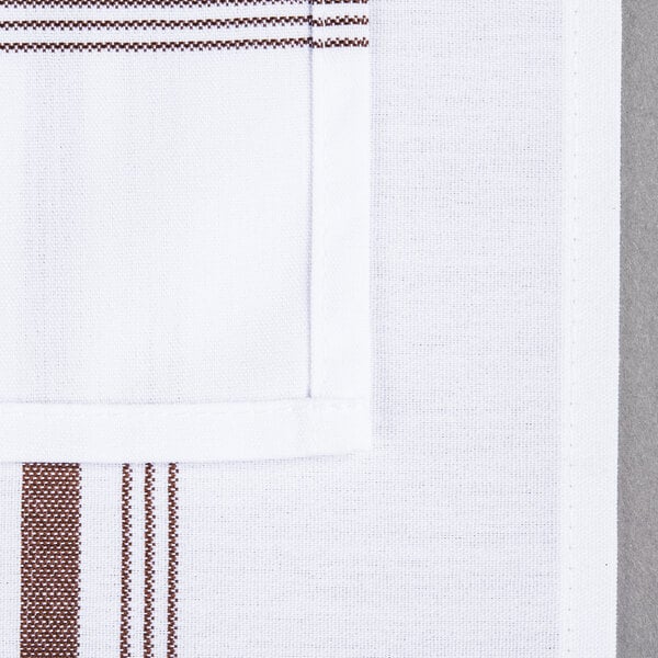 A white cloth napkin with a brown stripe down the middle.