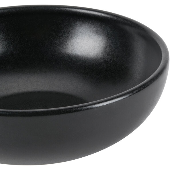 A close up of a black Hall China large bistro bowl.