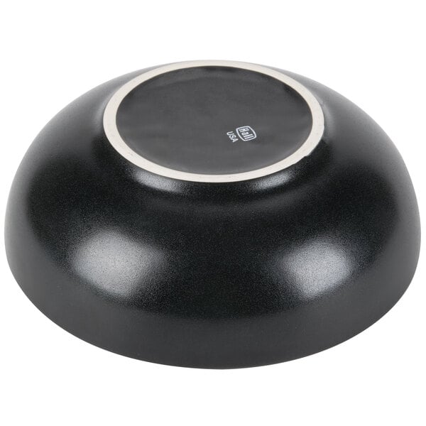 A black Hall China bistro bowl with a white border.