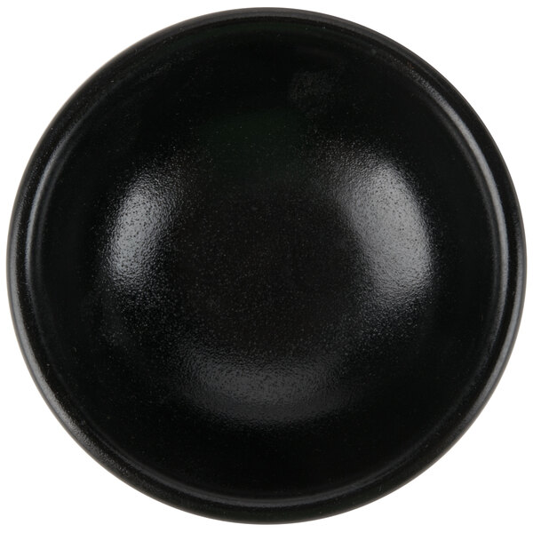 A black Hall China ramekin with a white background.