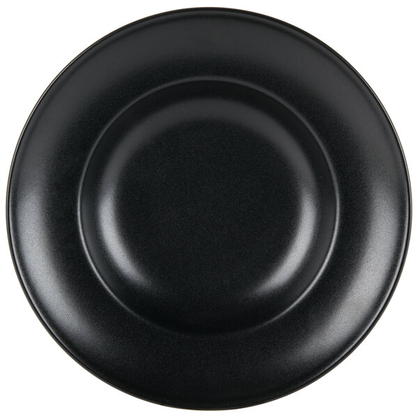 A close up of a black Hall China Mediterranean pasta bowl with a circular design.