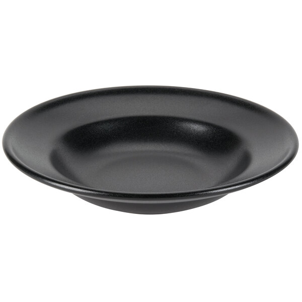 A close-up of a black Hall China Mediterranean rim soup bowl.