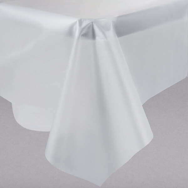 A clear plastic table cover on a table with a crease.