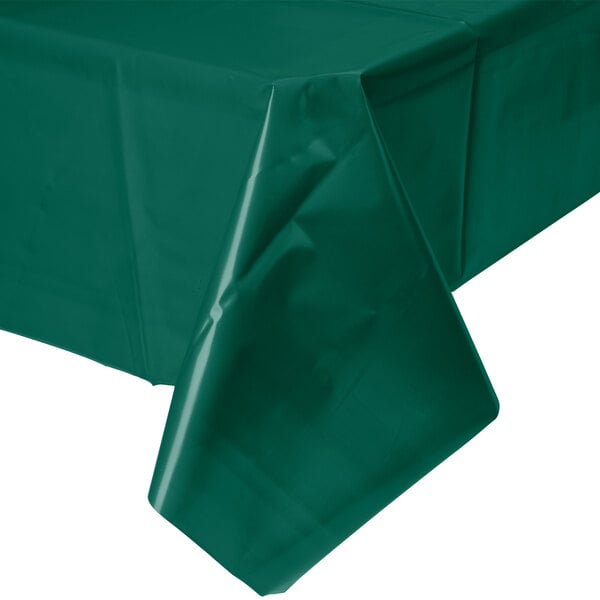 A Hunter Green Creative Converting plastic table cover on a table.