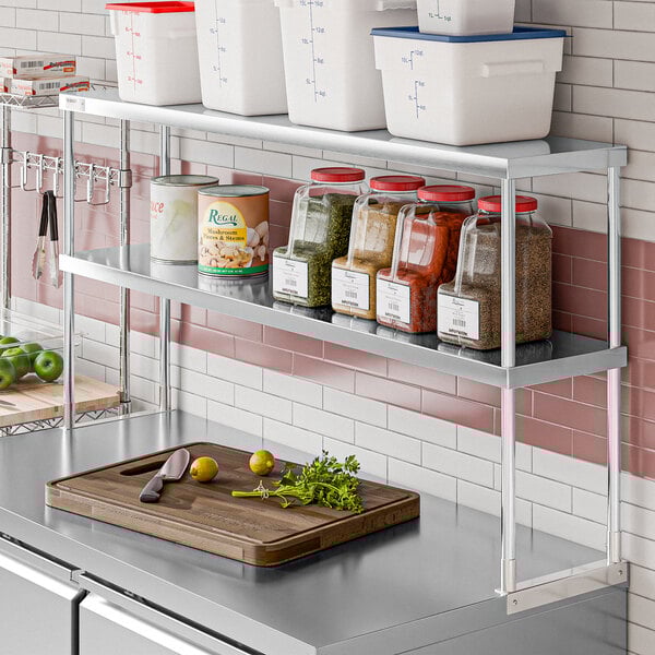 An Avantco stainless steel double deck overshelf with food on it.