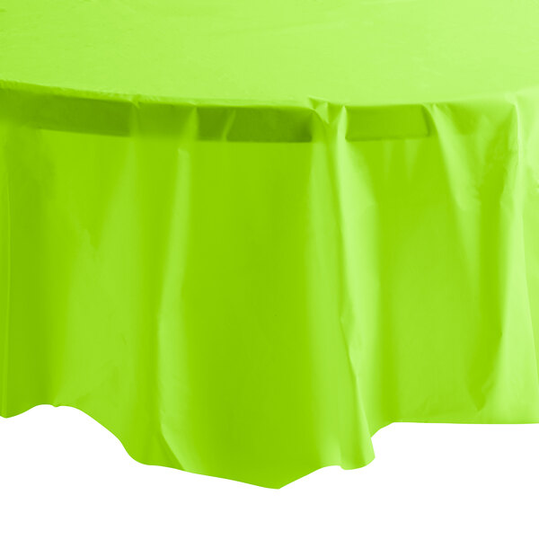 A green Creative Converting tablecloth on a table.