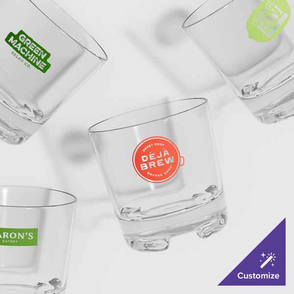 A close-up of a GET SAN plastic rocks glass with a logo on it.