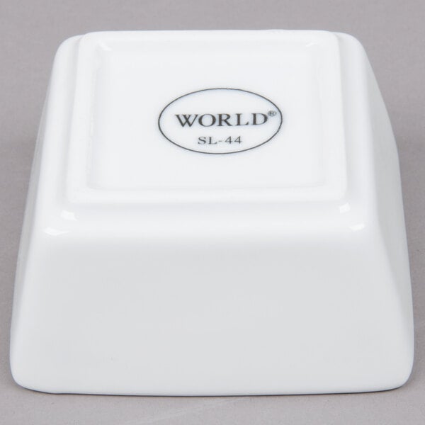 A white square Libbey porcelain dipping bowl.