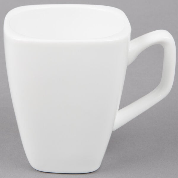 A close-up of a Libbey Ultra Bright White tall porcelain cup with a handle.
