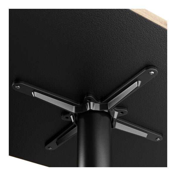 A black table with a FLAT Tech black metal table leg.